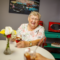 Senior woman smiling while eating ice cream in the "diner"