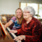 IMG_0840 Staff Member sitting with resident while she plays the piano