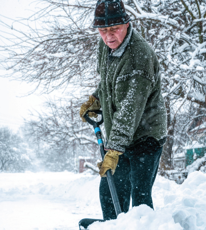 Senior man shoveling in a blizzard